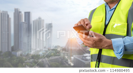 Civil engineer architect Using a smartphone to communicate and give orders to the construction team, Engineer building concept, Background for construction, Technology to construction. 114980495
