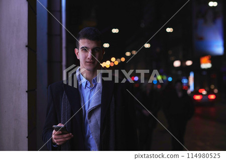 Smiling Meedle Eastern man walking down street near modern office building, 114980525