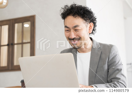 Man using a computer 114980579