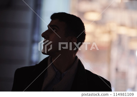 Smiling Meedle Eastern man walking down street near modern office building, 114981109