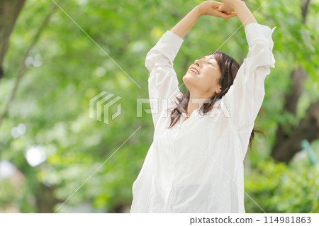 Middle-aged woman refreshing in the park 114981863