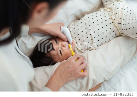 mother brushing her daughters teeth. happy baby with tooth brush mother brushing her daughters teeth. happy baby with tooth brush 114982335