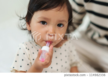 baby girl takes syrup medicine. sick toddler 114982336