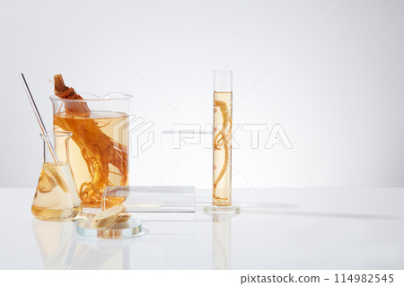 Minimalist photo with frontal shot on white background, lab items consist of measuring cylinder, beaker and erlenmeyer surrounded a rectangular platform, placed on the left side. Copy space for text Minimalist photo with frontal shot on white background, lab items consist of measuring cylinder, beaker and erlenmeyer surrounded a rectangular platform, placed on the left side. Copy space for text 114982545