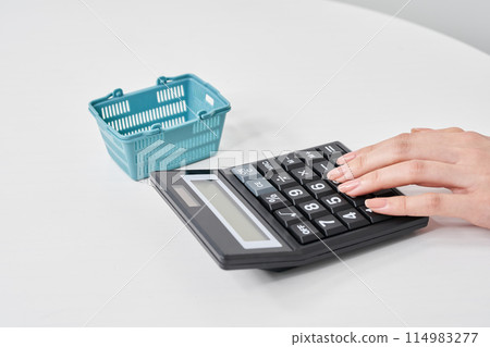 Hands of a woman using a calculator Hands of a woman using a calculator 114983277