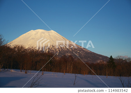 Hokkaido in winter: Mt. Yotei seen from the west side as it is dyed in the sunset Hokkaido in winter: Mt. Yotei seen from the west side as it is dyed in the sunset 114983542