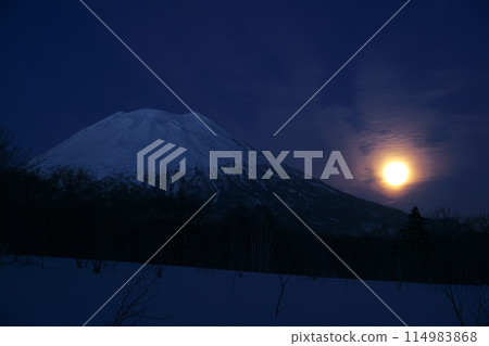 Hokkaido in winter: Mt. Yotei and the hazy moon seen from the west side of Mt. Yotei 114983868