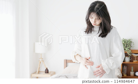 A woman who worries about her belly A woman who worries about her belly 114984647
