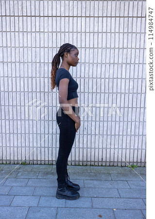 Young Woman in Profile with Urban Background 114984747