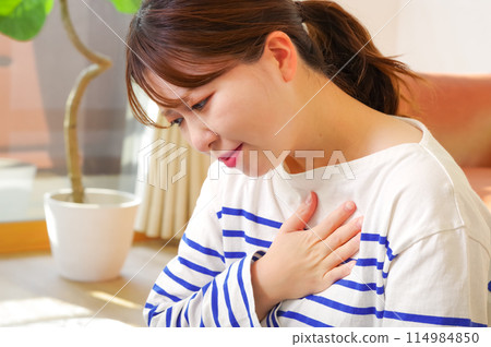 A woman with chest pain A woman with chest pain 114984850