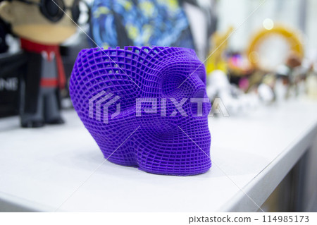 Prototype of human skull printed on 3D printer from molten purple plastic. Modern new printing manufacturing. Additive progressive medical technology. Three-dimensional model skull 3D printed close-up Prototype of human skull printed on 3D printer from molten purple plastic. Modern new printing manufacturing. Additive progressive medical technology. Three-dimensional model skull 3D printed close-up 114985173