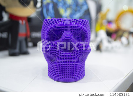 Prototype of human skull printed on 3D printer from molten purple plastic. Modern new printing manufacturing. Additive progressive medical technology. Three-dimensional model skull 3D printed close-up Prototype of human skull printed on 3D printer from molten purple plastic. Modern new printing manufacturing. Additive progressive medical technology. Three-dimensional model skull 3D printed close-up 114985181
