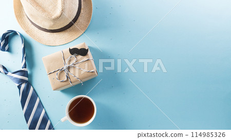 Happy Fathers Day background concept with gift box, decorated bow tie, necktie and mustache on bright pastel background. 114985326