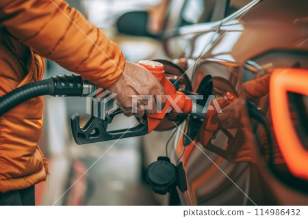 Man refuels car with various parts at gas station 114986432