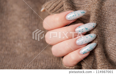 Female hands with blue nail design. Blue nail polish manicure. Female hands with blue nail design. Blue nail polish manicure. 114987001