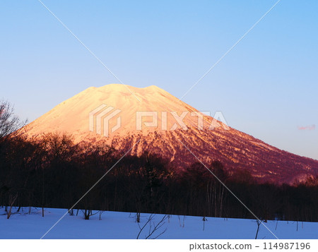 Hokkaido in winter: Mt. Yotei seen from the west side as it is dyed in the sunset Hokkaido in winter: Mt. Yotei seen from the west side as it is dyed in the sunset 114987196