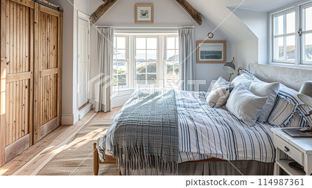 Beautiful interior of luxury bedroom with window sea view. Coastal cottage concept. High quality photo 114987361