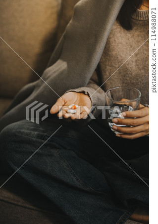 Upset woman frustrated by problem with work or relationships, sitting on couch, embracing knees, covered face in hand, feeling despair and anxiety, loneliness, having psychological trouble 114988071