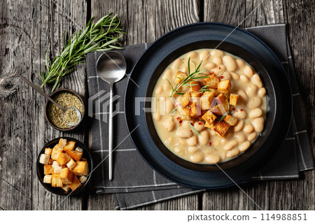 rosemary garlic creamy white bean soup in bowl rosemary garlic creamy white bean soup in bowl 114988851