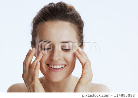 happy young woman doing facial massage happy young woman doing facial massage 114993088