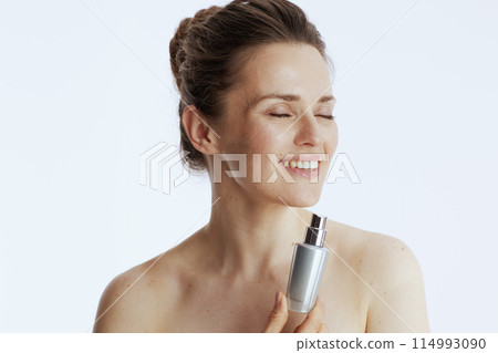 smiling modern woman with cosmetic cream jar 114993090