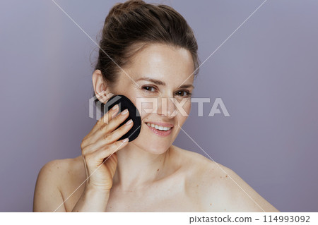 Portrait of smiling modern woman with cotton pad 114993092