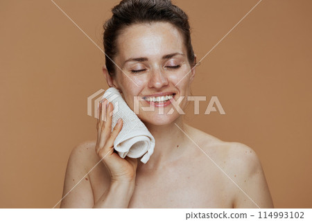 happy woman with towel washing face 114993102