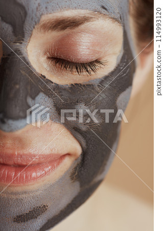 Closeup on modern 40 years old woman with cosmetic mask 114993120
