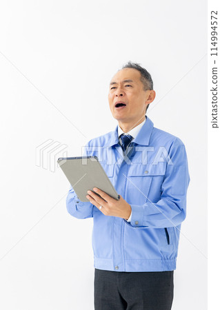 Man in work clothes, tablet, vertical Man in work clothes, tablet, vertical 114994572