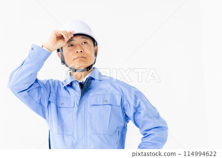 Man in work clothes wearing a helmet 114994622