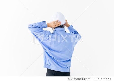 Man in work clothes, helmet, back view 114994635