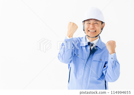 Man in work clothes, helmet, fist pump 114994655