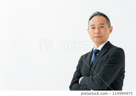 Middle male business arms crossed Middle male business arms crossed 114994975