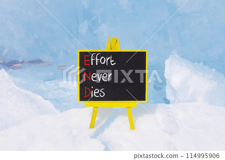 END effort never dies symbol. Concept words END effort never dies on beautiful yellow blackboard. Beautiful blue ice background. Business END effort never dies concept. Copy space. 114995906