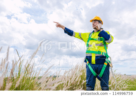engineer male control operate field working outdoor service maintenance wind power generator. worker hand pointing location to order gesture engineer male control operate field working outdoor service maintenance wind power generator. worker hand pointing location to order gesture 114996759