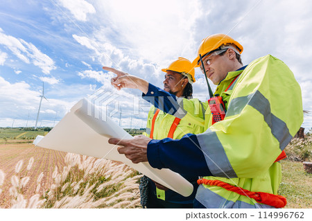 Engineer team working group survey at wind turbine clean power generator service maintenance wind mill outdoor. 114996762