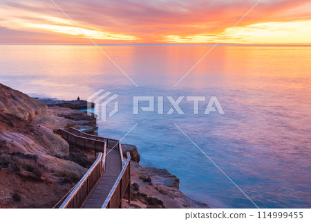 SouthPort beach boardwalk with silhouette of fisherman on shore SouthPort beach boardwalk with silhouette of fisherman on shore 114999455