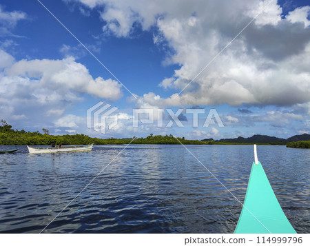 Men on a Motorized Outrigger Boat 114999796