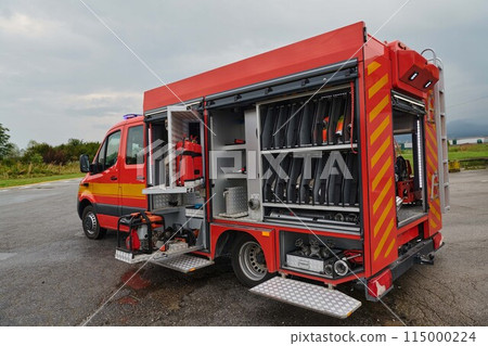 A state-of-the-art firetruck, equipped with advanced rescue technology, stands ready with its skilled firefighting team, prepared to intervene and respond rapidly to emergencies, ensuring the safety A state-of-the-art firetruck, equipped with advanced rescue technology, stands ready with its skilled firefighting team, prepared to intervene and respond rapidly to emergencies, ensuring the safety 115000224