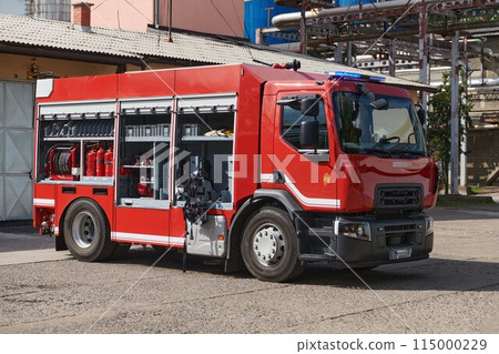 A state-of-the-art firetruck, equipped with advanced rescue technology, stands ready with its skilled firefighting team, prepared to intervene and respond rapidly to emergencies, ensuring the safety 115000229