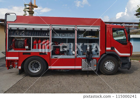 A state-of-the-art firetruck, equipped with advanced rescue technology, stands ready with its skilled firefighting team, prepared to intervene and respond rapidly to emergencies, ensuring the safety 115000241
