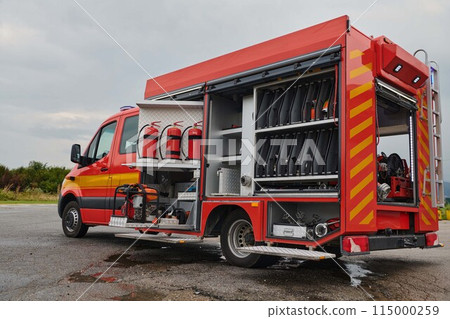 A state-of-the-art firetruck, equipped with advanced rescue technology, stands ready with its skilled firefighting team, prepared to intervene and respond rapidly to emergencies, ensuring the safety A state-of-the-art firetruck, equipped with advanced rescue technology, stands ready with its skilled firefighting team, prepared to intervene and respond rapidly to emergencies, ensuring the safety 115000259