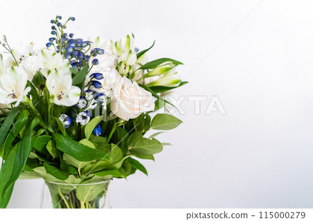 A stunning bouquet featuring fresh white roses and assorted flowers gracefully arranged in a vase, exuding timeless beauty. A stunning bouquet featuring fresh white roses and assorted flowers gracefully arranged in a vase, exuding timeless beauty. 115000279