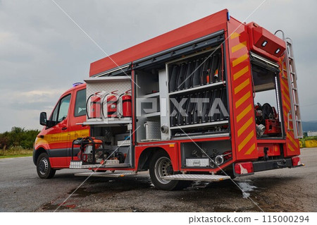 A state-of-the-art firetruck, equipped with advanced rescue technology, stands ready with its skilled firefighting team, prepared to intervene and respond rapidly to emergencies, ensuring the safety A state-of-the-art firetruck, equipped with advanced rescue technology, stands ready with its skilled firefighting team, prepared to intervene and respond rapidly to emergencies, ensuring the safety 115000294