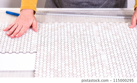 In the process of mounting peel and stick mosaic tiles onto a foam board, perfect for enhancing a food photography studio's aesthetic. In the process of mounting peel and stick mosaic tiles onto a foam board, perfect for enhancing a food photography studio's aesthetic. 115000295