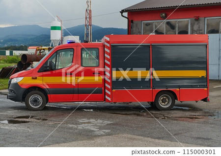 A state-of-the-art firetruck, equipped with advanced rescue technology, stands ready with its skilled firefighting team, prepared to intervene and respond rapidly to emergencies, ensuring the safety 115000301
