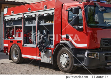 A state-of-the-art firetruck, equipped with advanced rescue technology, stands ready with its skilled firefighting team, prepared to intervene and respond rapidly to emergencies, ensuring the safety 115000313