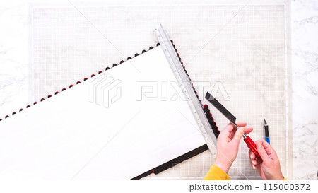 Flat lay. In the process of mounting peel and stick mosaic tiles onto a foam board, perfect for enhancing a food photography studio's aesthetic. 115000372