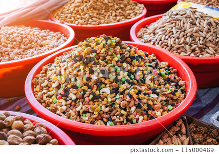 traditional Uzbek sweet mix of various varieties of nuts, dried fruits, oriental sweets on the counter in Asian market 115000489