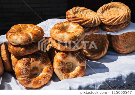 traditional Asian bread Uzbek tandoor flatbread on counter at bazaar in Uzbekistan traditional Asian bread Uzbek tandoor flatbread on counter at bazaar in Uzbekistan 115000547